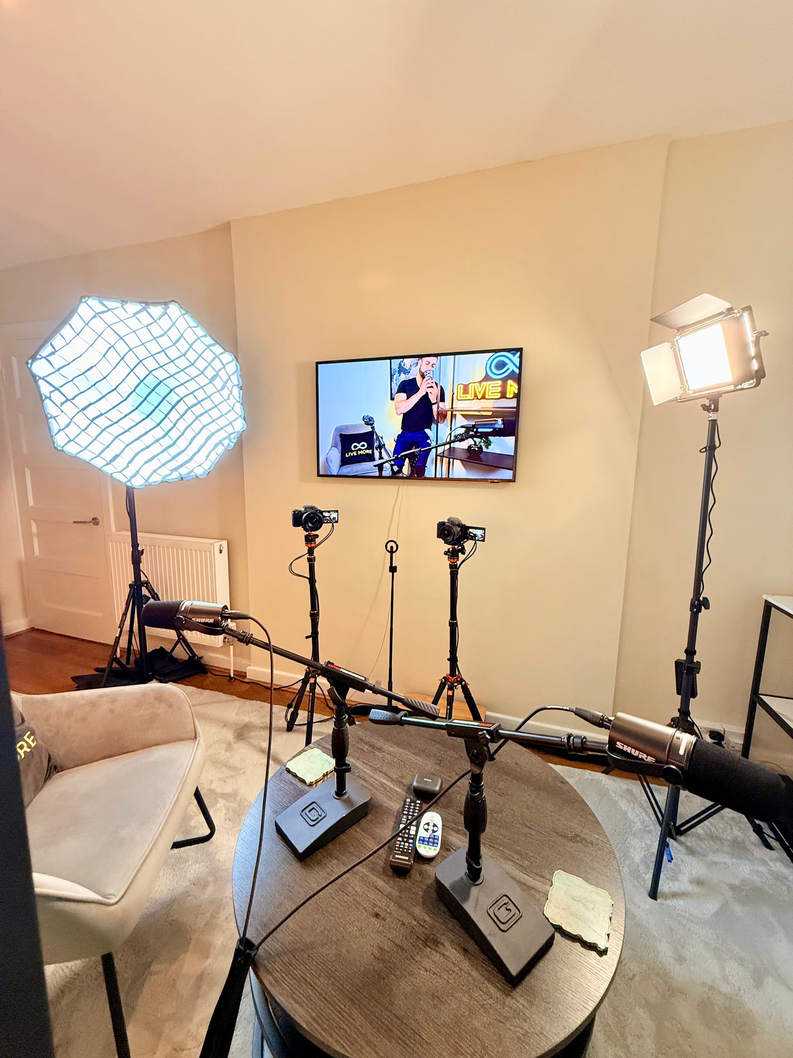 Professional video studio setup featuring cameras, microphones, and studio lighting equipment in a room.