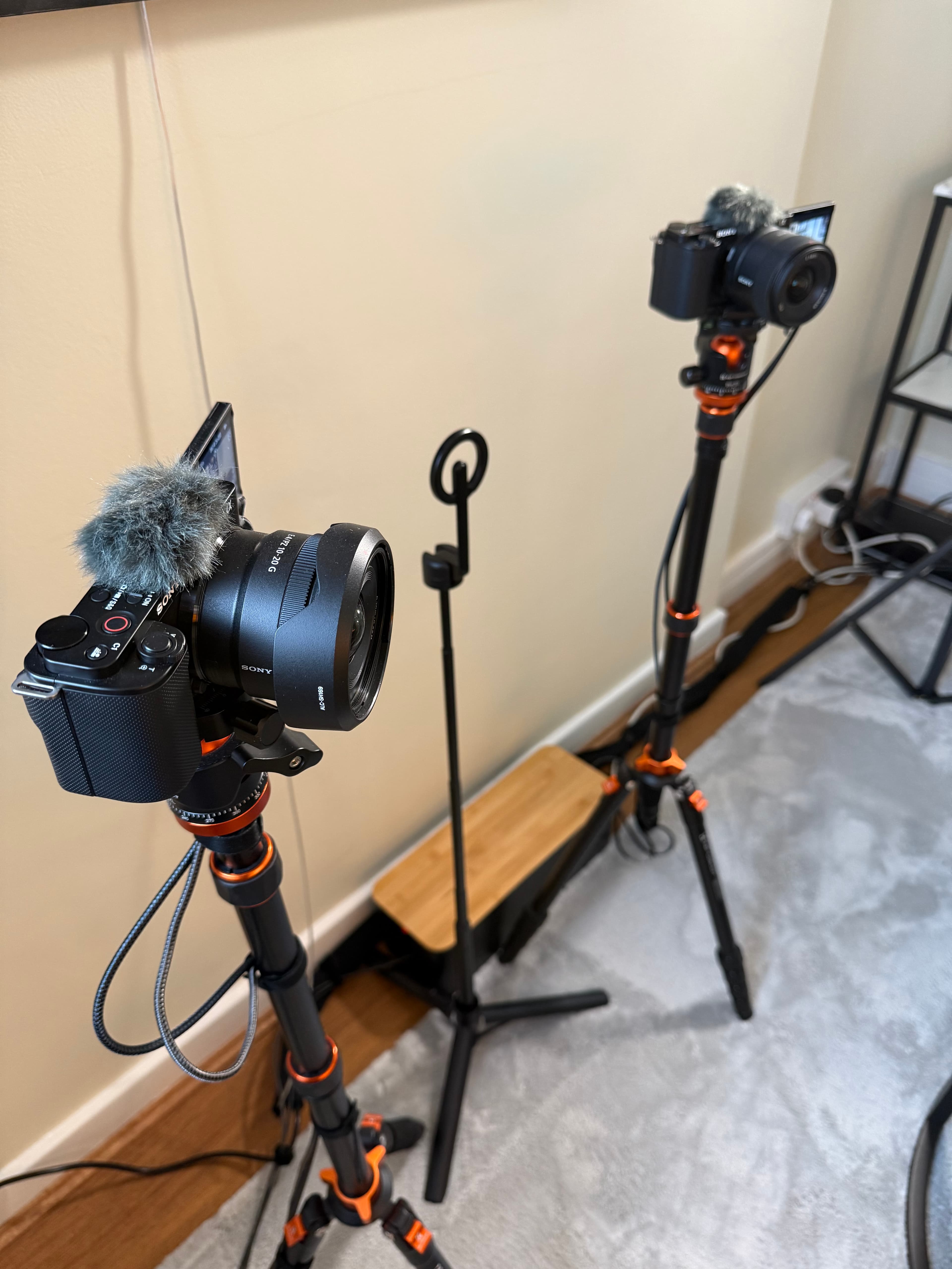 Two Sony cameras with furry microphones on tripods, positioned for a multi-camera video shoot.